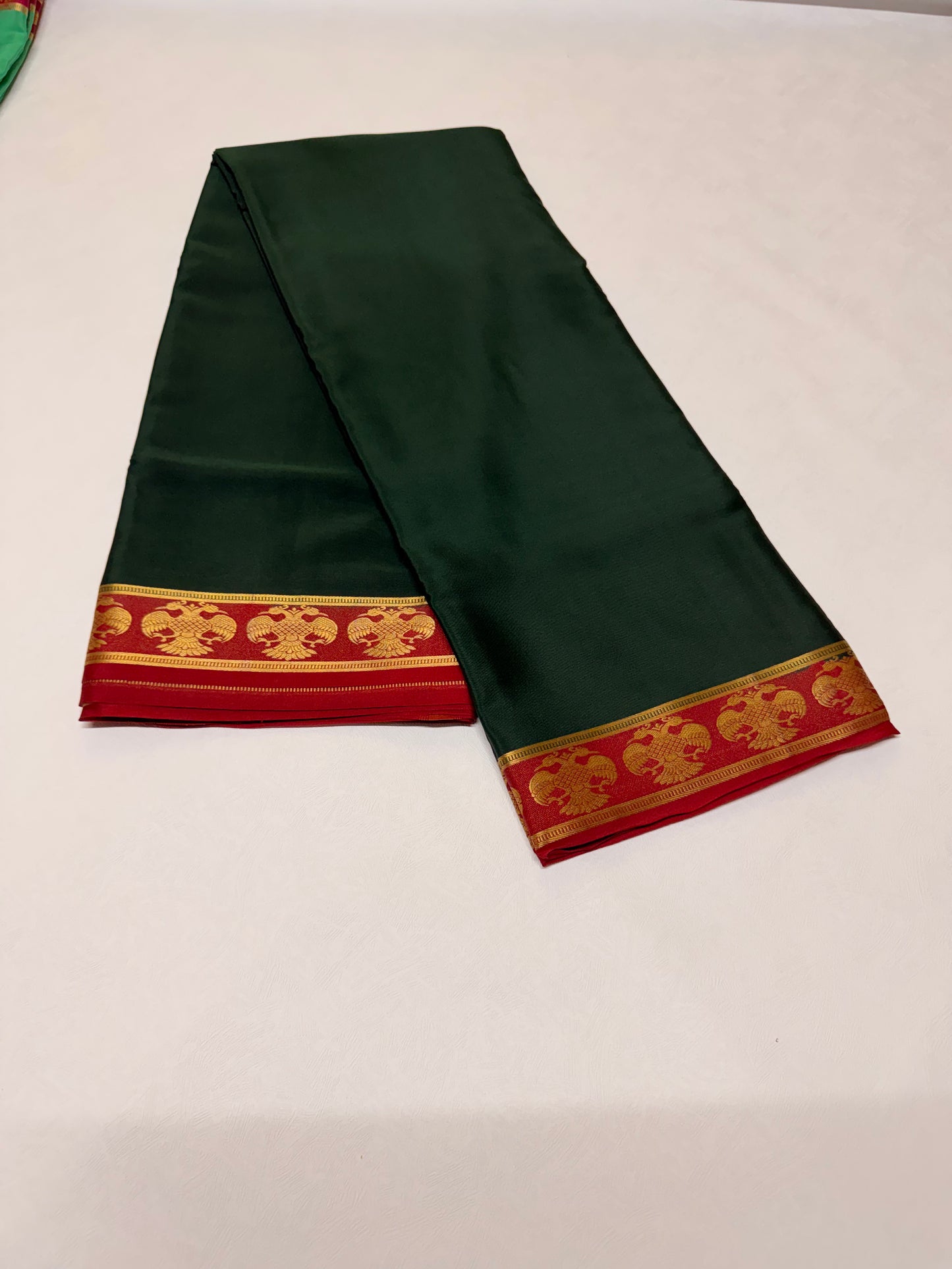 Neelavalli — Deep Bottle Green Silk Saree with Red & Gold Gandaberunda Border